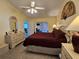 Spacious main bedroom featuring a ceiling fan and tile floors, providing comfort and style at 2210 Bayou Dr, Holiday, FL 34691