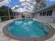 Inviting screened-in pool area with a built-in spa and ample space for outdoor enjoyment at 2210 Bayou Dr, Holiday, FL 34691