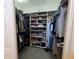 Organized walk-in closet featuring shelves, hanging racks, and ample storage space at 2210 Bayou Dr, Holiday, FL 34691