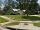 Inviting exterior of the home with a well-maintained lawn and mature trees in a desirable neighborhood at 2215 Toniwood Ln, Palm Harbor, FL 34685