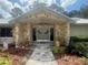 Inviting stone facade entrance with a charming walkway and well-manicured landscaping at 2215 Toniwood Ln, Palm Harbor, FL 34685