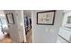 Hallway view of a walk-in closet, bathroom, and bedroom area, painted in neutral tones at 2215 Toniwood Ln, Palm Harbor, FL 34685