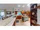 A well-appointed kitchen with hardwood floors, wooden cabinetry, granite countertops, and a charming central island at 2215 Toniwood Ln, Palm Harbor, FL 34685