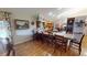A modern kitchen with hardwood floors, wooden cabinets, a lengthy bar counter, and an adjacent dining area at 2215 Toniwood Ln, Palm Harbor, FL 34685