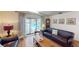 Cozy living room with comfortable seating, hardwood floors, and a view of the pool area through sliding doors at 2215 Toniwood Ln, Palm Harbor, FL 34685