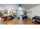 Spacious living room featuring hardwood floors, ample seating, and natural light from sliding glass doors at 2215 Toniwood Ln, Palm Harbor, FL 34685