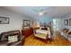 Calm main bedroom with hardwood floors, neutral paint, and a large window for natural light at 2215 Toniwood Ln, Palm Harbor, FL 34685