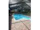 Inviting screened-in pool with brick paver deck perfect for relaxing and entertaining at 2215 Toniwood Ln, Palm Harbor, FL 34685