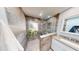 Modern shower stall featuring neutral tile, glass enclosure, and decorative plants for a spa-like feel at 2215 Toniwood Ln, Palm Harbor, FL 34685