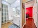 Bright bathroom featuring a shower-tub combo, white vanity, and modern fixtures with a view to the next room at 22804 Willow Lakes Dr, Lutz, FL 33549