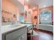 Bathroom features double sinks, tub, a shower and a window with glass blocks for privacy at 22804 Willow Lakes Dr, Lutz, FL 33549