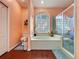 The spacious bathroom features a large glass block window above a garden tub and a separate shower at 22804 Willow Lakes Dr, Lutz, FL 33549
