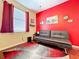 Bedroom featuring a sofa, wood floors, and decor and a window at 22804 Willow Lakes Dr, Lutz, FL 33549