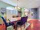 Bright dining room with large window and modern chandelier lighting at 22804 Willow Lakes Dr, Lutz, FL 33549