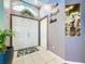 Inviting foyer with double doors, decorative accents and neutral tile flooring at 22804 Willow Lakes Dr, Lutz, FL 33549