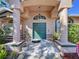 Inviting front entrance with decorative columns and lush landscaping at 22804 Willow Lakes Dr, Lutz, FL 33549