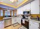 Modern kitchen with white cabinets, stainless steel appliances, and lots of sunlight at 22804 Willow Lakes Dr, Lutz, FL 33549