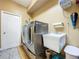 Functional laundry room with a modern washer and dryer set and a utility sink at 22804 Willow Lakes Dr, Lutz, FL 33549