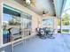 Enclosed patio with outdoor seating arrangements and ceiling fans at 22804 Willow Lakes Dr, Lutz, FL 33549