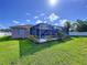 Backyard view of a screened-in private pool with lush landscaping at 22804 Willow Lakes Dr, Lutz, FL 33549