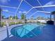 Gorgeous screen-enclosed pool is surrounded by a patio and lush landscaping at 22804 Willow Lakes Dr, Lutz, FL 33549