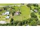 Elevated aerial view presenting the home's layout, including a swimming pool, the well-kept lawn, and boundary lines of the property at 23075 Hayman Rd, Brooksville, FL 34602