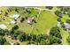 Aerial view of property showing the home, pool, and landscaping along with a wide view of the surrounding greenery at 23075 Hayman Rd, Brooksville, FL 34602