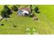 Bird's eye view of the home, highlighting the enclosed pool area, landscaped patio, and the expansive green lawn at 23075 Hayman Rd, Brooksville, FL 34602