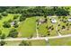 Expansive aerial view of a large property, with lush green acreage and a well-maintained home nestled within the landscape at 23075 Hayman Rd, Brooksville, FL 34602