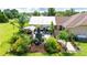 Backyard featuring a covered patio, outdoor kitchen, mature landscaping, and ample space for entertaining at 23075 Hayman Rd, Brooksville, FL 34602