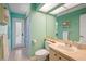 Bright bathroom featuring tile flooring, decorative shower curtain, and a modern sink at 23075 Hayman Rd, Brooksville, FL 34602