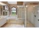 This bathroom features a tub with tile surround and a glass enclosed shower at 23075 Hayman Rd, Brooksville, FL 34602
