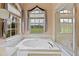 This bathroom features a tub and a large window with a view of the outside at 23075 Hayman Rd, Brooksville, FL 34602