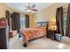 This bedroom features a ceiling fan, neutral carpet, and a window to let natural light into the room at 23075 Hayman Rd, Brooksville, FL 34602