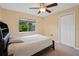 This bedroom features a ceiling fan, closet and a window that lets in natural light at 23075 Hayman Rd, Brooksville, FL 34602