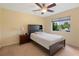 Bedroom featuring ceiling fan, neutral carpet and a window that lets in natural light at 23075 Hayman Rd, Brooksville, FL 34602