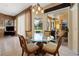 Cozy breakfast nook with a glass top table, comfortable chairs, and a view of the outdoor pool area at 23075 Hayman Rd, Brooksville, FL 34602