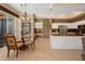 Open-concept dining area near the kitchen with tile flooring and a glass table, perfect for Gathering meals at 23075 Hayman Rd, Brooksville, FL 34602