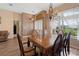 Spacious dining area with hardwood floors, stylish lighting, and large windows at 23075 Hayman Rd, Brooksville, FL 34602