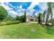 Exterior of home with a charming wooden fence, lush green lawn, and a 2-car garage at 23075 Hayman Rd, Brooksville, FL 34602