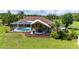 The back of the home features a screened-in pool and covered patio, creating an outdoor living space at 23075 Hayman Rd, Brooksville, FL 34602