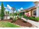 Landscaped garden area featuring lush green plants, mulch, and decorative flowers at 23075 Hayman Rd, Brooksville, FL 34602