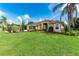 Well-maintained single Gathering home with beautiful landscaping, mature trees, and a lush green lawn at 23075 Hayman Rd, Brooksville, FL 34602