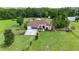 Charming single-story home with well-manicured lawn, mature trees, and a screened-in porch at 23075 Hayman Rd, Brooksville, FL 34602