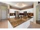 Bright, open kitchen with granite countertops, stainless steel appliances, and a convenient kitchen island at 23075 Hayman Rd, Brooksville, FL 34602