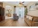 Comfortable living room with hardwood flooring, neutral colors, and a view to the dining area at 23075 Hayman Rd, Brooksville, FL 34602