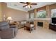 Spacious living room featuring comfortable seating, a fireplace with stone accents, and tile flooring at 23075 Hayman Rd, Brooksville, FL 34602