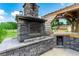 Outdoor fireplace constructed with stone near an outdoor kitchen at 23075 Hayman Rd, Brooksville, FL 34602