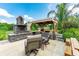 An outdoor kitchen area featuring stone design and a grill at 23075 Hayman Rd, Brooksville, FL 34602