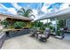 Outdoor kitchen with chairs and a grill for entertaining at 23075 Hayman Rd, Brooksville, FL 34602